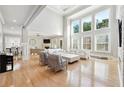 Open-concept living area features high ceilings, large windows, and hardwood floors at 3423 Jamont Blvd, Alpharetta, GA 30022
