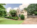 Well-maintained home featuring a two-car garage, basketball hoop, and manicured landscaping at 4045 Hillcrest View Ct, Suwanee, GA 30024