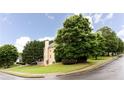 Exterior side view of home with a spacious yard, mature trees, and manicured shrubbery at 4045 Hillcrest View Ct, Suwanee, GA 30024