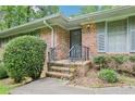 Close-up of the brick entrance, steps, and wrought iron railing to the front door at 415 Haven Ln, Marietta, GA 30066