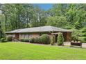 Spacious one-story home with landscaped front yard, arbor covered walkway, and private parking at 415 Haven Ln, Marietta, GA 30066