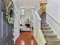 Open living room with high ceilings, fireplace, hardwood floors, and staircase at 4284 Cabretta Se Dr, Smyrna, GA 30080