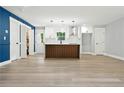 Bright kitchen with island, white cabinets, stainless hood, and modern pendant lights at 124 Sims Dr, Hiram, GA 30141