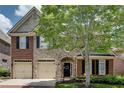 Lovely home showcasing brick and stone exterior with black shutters and a neatly landscaped front yard at 255 Wembley Cir, Atlanta, GA 30328