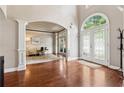 Spacious foyer with hardwood flooring, arched doorways, and a decorative glass front door at 302 Shawnee Indian Ln, Suwanee, GA 30024