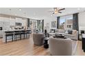 Open-concept living room with modern furnishings, hardwood floors, and a view of the kitchen at 332 Heavenly Hollow Pl, Mcdonough, GA 30253