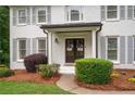 Charming white brick home with gray shutters and professionally landscaped front yard at 3600 Morishop Nw Cv, Marietta, GA 30064