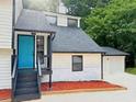 Exterior of home with a blue door, stone accents, and two car garage at 4411 Flakes Mill Rd, Ellenwood, GA 30294
