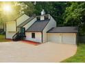 Exterior view of a two-story home with an attached two-car garage and driveway at 4411 Flakes Mill Rd, Ellenwood, GA 30294