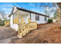 Charming single-story home with new stairs and wooden railing leading to the front door at 2331 Luther St, Lithonia, GA 30058