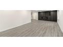 Spacious living room with gray floors and modern electric fireplace with built-in storage at 2331 Luther St, Lithonia, GA 30058