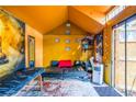 Vibrant orange shed interior featuring a futon, unique decor, and accents, perfect for a studio or office at 3182 Latona Sw Dr, Atlanta, GA 30354