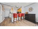 The kitchen features hardwood floors, a breakfast bar with red barstools, and stainless steel appliances at 800 Peachtree Ne St # 1504, Atlanta, GA 30308