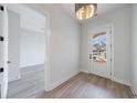Bright room featuring stylish wood-look flooring and a white door with a window to let in light at 160 South Village Ave, Holly Springs, GA 30115