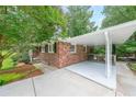 Attached carport provides covered parking and convenient access to this home with its classic brick exterior at 2889 Mount Olive Dr, Decatur, GA 30033