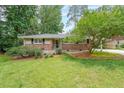 Charming single-story brick home with a well-maintained lawn, mature trees, and classic curb appeal at 2889 Mount Olive Dr, Decatur, GA 30033
