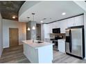 Modern kitchen featuring stainless steel appliances, a center island with a marble countertop, and pendant lighting at 361 17Th, Chattahoochee Hills, GA 30363
