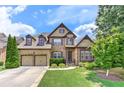 Two-story brick home boasts a well-manicured lawn and a two-car garage at 4924 Locklear Way, Marietta, GA 30066