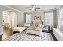 Spacious living room featuring a cozy sectional, decorative rug, and lots of natural light at 2023 Yellow Finch Trl, Atlanta, GA 30316
