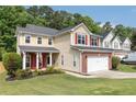 Inviting two-story home with a well-kept lawn, brick-accented garage, red shutters, and lovely curb appeal in a peaceful neighborhood at 3362 Palm Nw Cir, Kennesaw, GA 30144