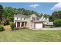 Inviting two-story home with a well-kept lawn, brick-accented garage, red shutters, and lovely curb appeal in a peaceful neighborhood at 3362 Palm Nw Cir, Kennesaw, GA 30144