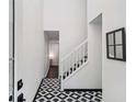 Entryway featuring black and white patterned tile and stairs at 5490 Chemin De Vie, Sandy Springs, GA 30342