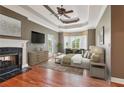 Spacious main bedroom with fireplace, tray ceiling, and access to an outdoor balcony at 55 Rocky Ne Cir, White, GA 30184