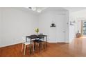 Cozy dining area with a modern black table and decor with hardwood floors and natural light at 711 Cosmopolitan Ne Dr # 300, Atlanta, GA 30324