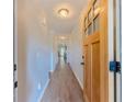 Inviting hallway with wood-look floors and a view of the living room at 10 Stewart Hollow Ln, Covington, GA 30016