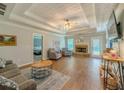 Spacious living room with tray ceilings, a fireplace, and lots of natural light at 10 Stewart Hollow Ln, Covington, GA 30016