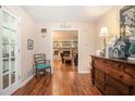 Inviting foyer with hardwood floors, decorative chair, and a view into the living room at 1310 Chilton Woods Rd, Rutledge, GA 30663