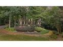 Charming two-story home with a welcoming front porch and beautifully landscaped front yard, surrounded by mature trees at 2722 Brookhaven Ln, Buford, GA 30518