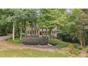 Charming two-story home with a welcoming front porch and beautifully landscaped front yard, surrounded by mature trees at 2722 Brookhaven Ln, Buford, GA 30518