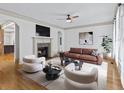 Bright living room features a fireplace, hardwood floors, neutral colors, and a ceiling fan at 187 Vanira Se Ave, Atlanta, GA 30315