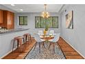 Open concept dining area with a round glass table and modern chandelier at 3048 Briarcliff Ne Rd # 8, Atlanta, GA 30329