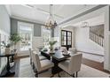 Dining room with stylish lighting, large windows, and access to the front entry at 3185 Casteel Ne Rd, Marietta, GA 30062