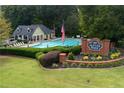 Beautiful community pool area with lounge chairs, lush landscaping, and a welcoming sign, ideal for relaxation and recreation at 4146 Mcever Park Dr, Acworth, GA 30101