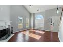 Sunlit living room featuring hardwood floors, fireplace, large windows, and an open layout, perfect for entertaining and Gathering time at 4146 Mcever Park Dr, Acworth, GA 30101