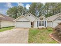 Inviting one-story home with fresh landscaping, attached garage, and cozy facade at 713 S Fairfield Dr, Peachtree City, GA 30269