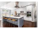 Modern kitchen featuring a large center island, stainless steel appliances, and updated lighting at 892 Gramercy Hills Ln, Mableton, GA 30126