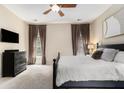 Spacious main bedroom with plush carpeting, a ceiling fan, and natural light from two windows at 892 Gramercy Hills Ln, Mableton, GA 30126