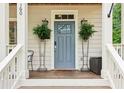 Charming front porch featuring a blue door, perfect for enjoying the outdoors and neighborhood views at 1160 Foster Nw Pl, Atlanta, GA 30318