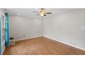 Large living room featuring light-colored walls, hardwood floor and a ceiling fan at 1594 Pine Glen Cir, Decatur, GA 30035