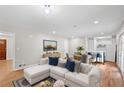 Spacious living room with modern furniture, hardwood floor and adjacent kitchen area at 1594 Pine Glen Cir, Decatur, GA 30035