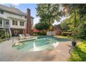 Inviting backyard pool with lounge chairs, perfect for relaxing and entertaining amidst serene surroundings at 314 Savannah Pl, Loganville, GA 30052