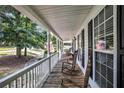 Inviting front porch with rocking chairs and views of the landscaped yard at 47 Glen Ridge Dr, Villa Rica, GA 30180