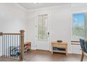 Bright entryway featuring hardwood floors, staircase, and natural light from the window at 5217 Riden Ct # 263, Buford, GA 30518