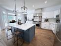 Modern kitchen featuring a large island, stainless steel appliances, and white cabinetry at 128 Golden Hills Dr, Woodstock, GA 30189