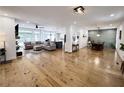 Open-concept living room featuring a comfortable sectional sofa, area rug, and hardwood flooring at 128 Golden Hills Dr, Woodstock, GA 30189
