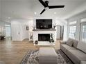 Living room featuring a fireplace, hardwood floors, and an inviting, cozy atmosphere at 128 Golden Hills Dr, Woodstock, GA 30189